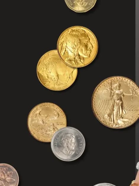 Gold and silver coins scattered on a charcoal surface