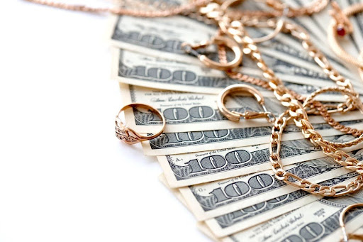 Gold jewlery and money.
